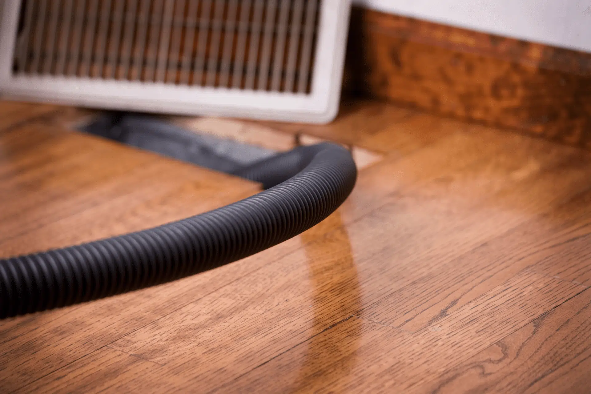 open vent with tube running into it in home