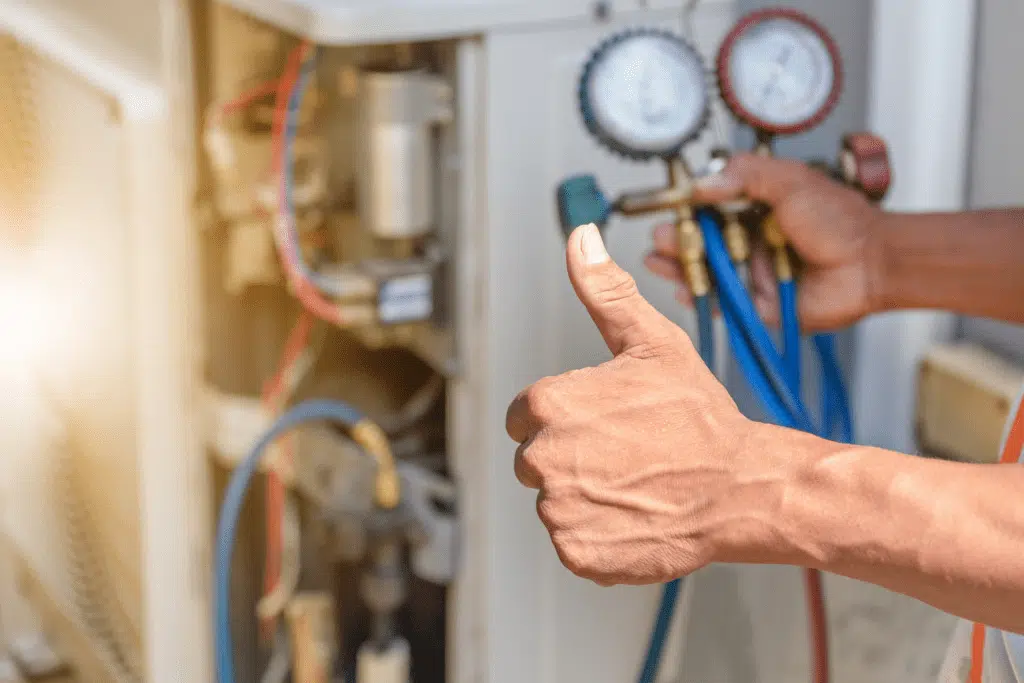 technician checking refrigerant levels of ac system