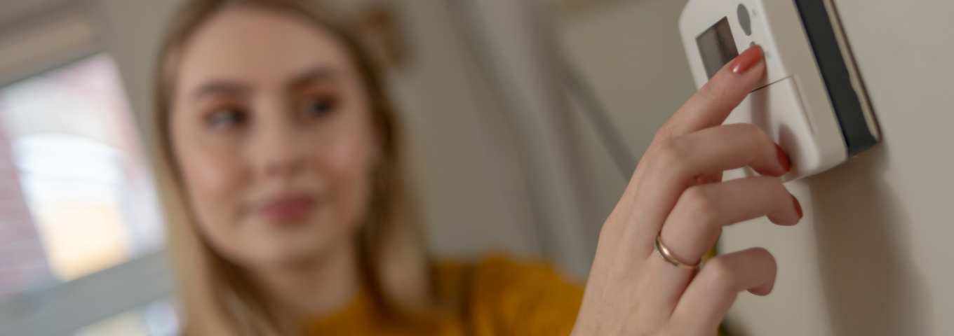 HVAC contractor repairing a thermostat